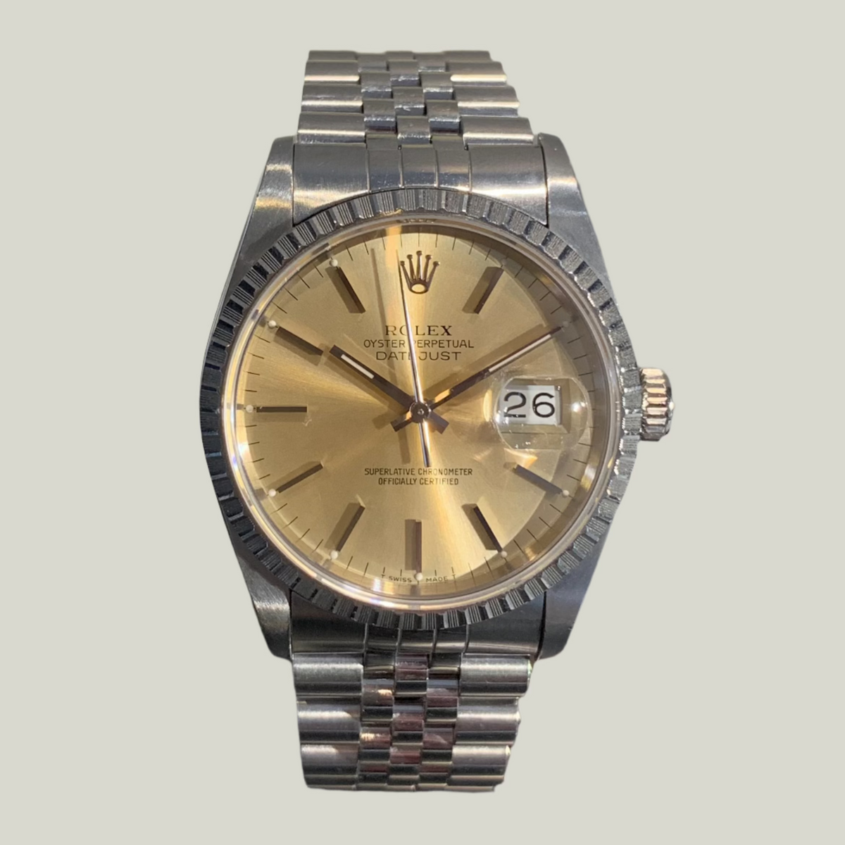 36mm Stainless Steel Rolex Datejust with a fluted bezel and a champagne baton dial on a jubilee bracelet.