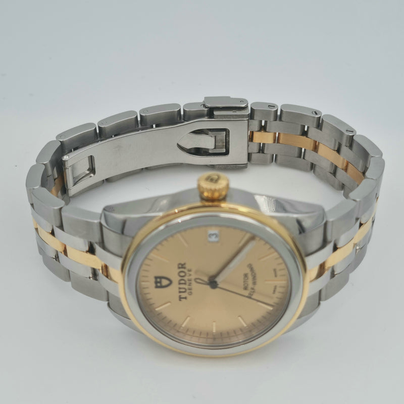 Tudor Glamour Gate 55003 with a two tone design of gold and steel on the bracelet and case, the dial is gold with no numerals. Sold in Swiss Watch Club store.